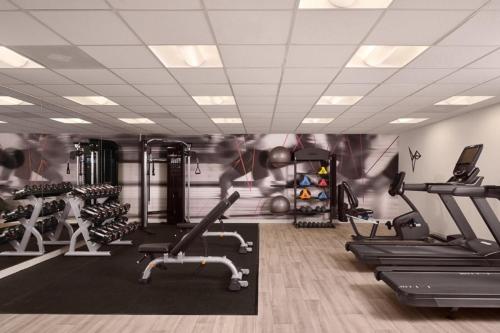 a gym with treadmills and exercise equipment in a room at Marriott Hutchinson Island Beach Resort, Golf & Marina in Stuart