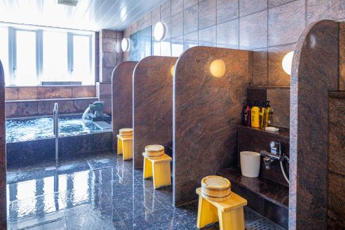 a bathroom with a shower and a tub with a sink at Hotel New Palace in Shingu