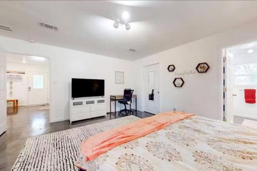 a bedroom with a large bed and a flat screen tv at Pensacola Coastal Retreat Near UWF Family-friendly in Olive