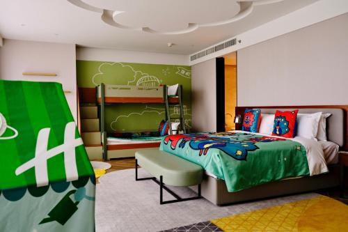 a bedroom with a bed and a chair in it at Holiday Inn Xi'an Chanba by IHG-Near Xi'an International Convention Exhibition Center and Shopping mall and The Romantic show of Xi'an-Free Luggage Storage-English Service in Xi'an