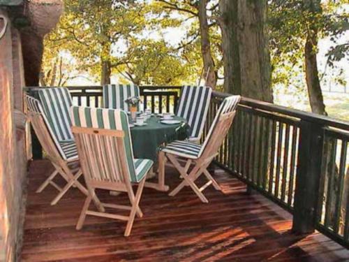 a table and four chairs on a deck at No 3 - Krautsand Comfortable Vacation Home in Krautsand