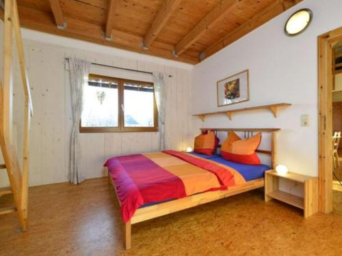 a bedroom with a bed with a colorful comforter at Holiday home Keim Comfortable Vacation Home in Negenborn