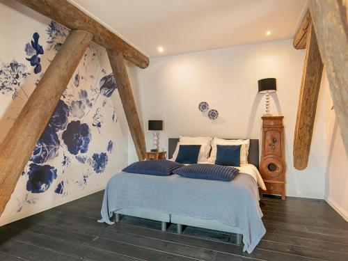 a bedroom with a bed with blue and white at Guesthouse Friesland Ternaard near Heritage in Ternaard