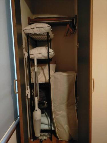 a room with a closet with pillows and a shelf at SapporoCity Ark Coat 203 in Minami-jūichijō