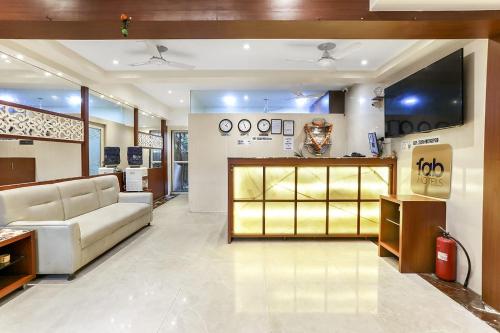 a room with a store with a couch and a television at FabHotel Spring inn - Nr Borivali Station in Mumbai