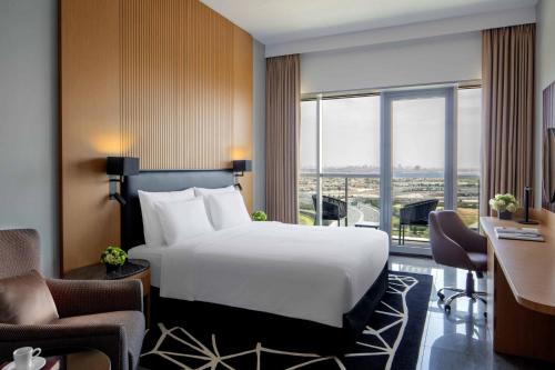 a hotel room with a large bed and a desk at The First Collection Dubai Business Bay in Dubai