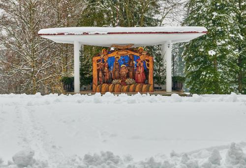 a shrine in the snow with a pile of snow at Hotel Palace - KÚPELE SLIAČ in Sliač