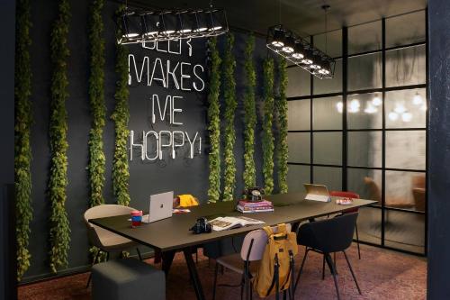 an office with a table with chairs and a sign that says only makes me happy at Moxy Edinburgh Fountainbridge in Edinburgh