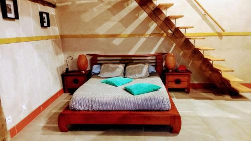 a bedroom with a bed with two pillows on it at La Coquille in Pouillon