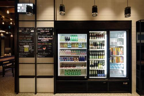 a drink cooler in a store with drinks in it at Moxy Osaka Umeda in Osaka