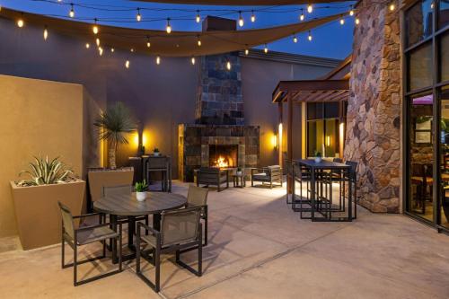 a patio with tables and chairs and a fireplace at The Westin Desert Willow Villas, Palm Desert in Palm Desert