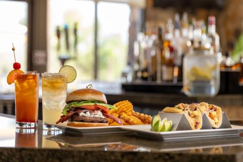 a sandwich and french fries and a drink on a table at The Westin Desert Willow Villas, Palm Desert in Palm Desert