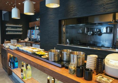 a kitchen with a buffet of food on a counter at APA Hotel Namba Shinsaibashi in Osaka