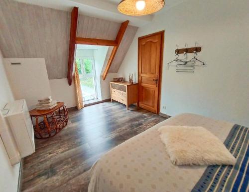 a bedroom with a bed and a wooden floor at Gîte de la Peyre et du Causse in Florimont-Gaumiers