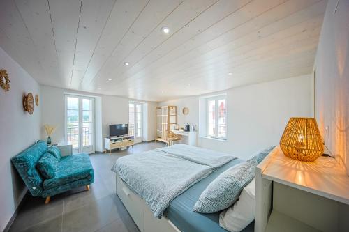 a bedroom with a bed and a table and a chair at Aloha chambres in Port-Valais