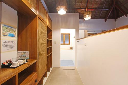 a hallway with wooden cabinets and a white wall at Yapak Beach Villas in San Isidro
