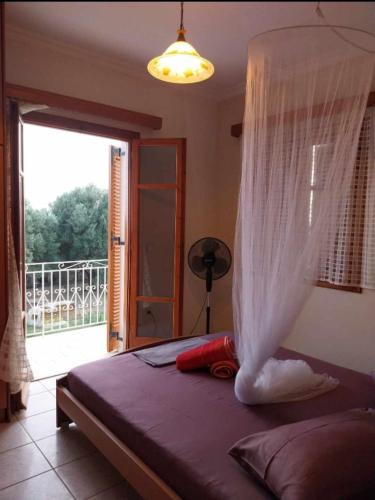 a bedroom with a bed with a mosquito net at Enjoy The Silence in Svoronata