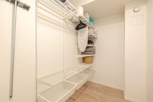 a walk in closet with white walls and white shelves at Uudistettu studio kahdelle omalla parkkipaikalla in Rovaniemi