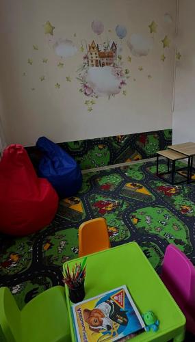 a room with a table and chairs on the floor at Алексік in Truskavets