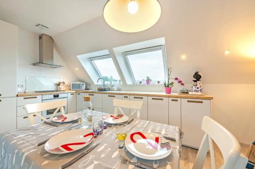 une cuisine avec une table et des chaises dans une cuisine dans l'établissement Appartement Plougasnou proche mer, à Plougasnou