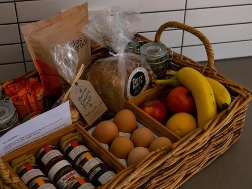 a basket filled with fruits and vegetables and eggs at Barossa Pavilions & Glasshouse in Lyndoch