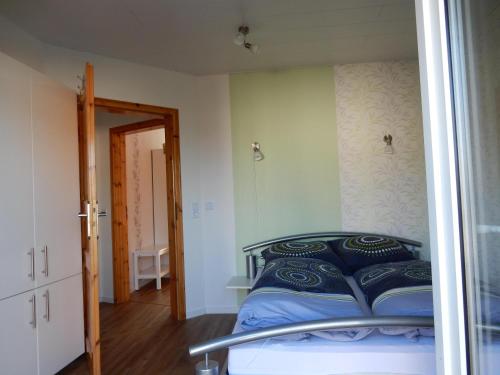a bedroom with a bed in a room with a mirror at Gina`s Ferienwohnung in Altweidelbach