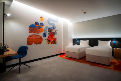 a bedroom with two beds and a table and a desk at AUHotel -Zayed International Airport-Located in Transit Area -Onwards Boarding Pass Required in Abu Dhabi