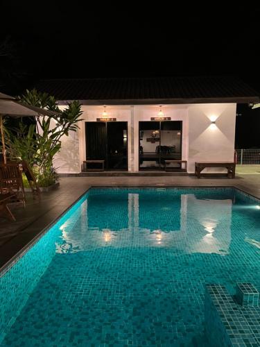 a swimming pool at night in front of a house at Villa The Quarry Segamat in Segamat