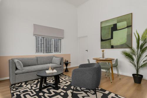 a living room with a couch and chairs at Neighbourgood Franschhoek in Franschhoek