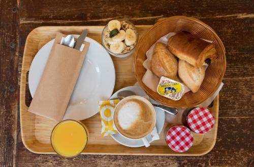 a tray with a basket of bread and a cup of coffee at Hotel Du Parlement in Brussels