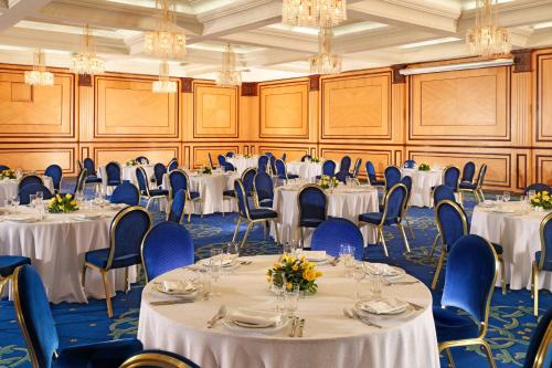 a banquet room with tables and chairs and chandeliers at Sheraton Tunis Hotel in Tunis