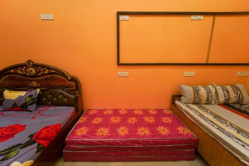 a room with two beds and a bench in it at RK appartment 3 bedroom with kitchen and balcony in Varanasi