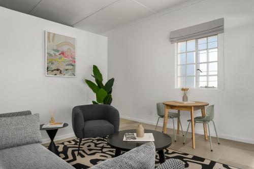 a living room with a couch and a table at Neighbourgood Franschhoek in Franschhoek