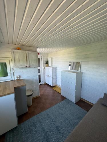 a kitchen with white cabinets and a wooden ceiling at Liu - Private paradise on Earth in Liu