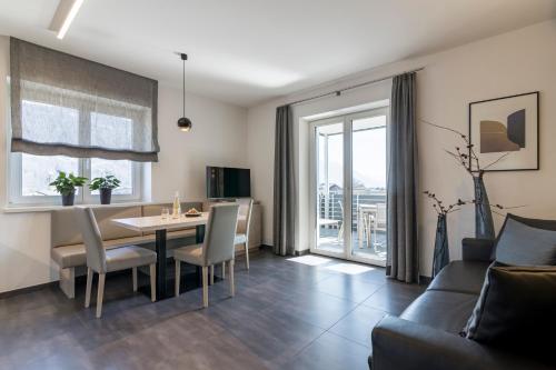 a living room with a table and a couch at Haus Wiesenstein in Lana