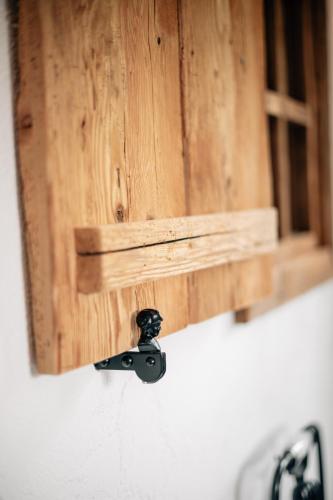 a bathroom mirror with a faucet in front at Hotel Sonnberg in Saalbach Hinterglemm