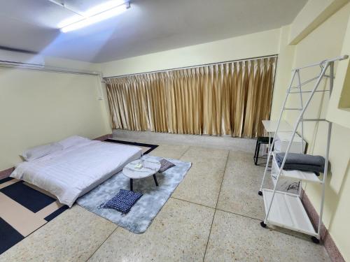 a bedroom with a bed and a ladder in it at 9 House&homeStay in Hat Yai