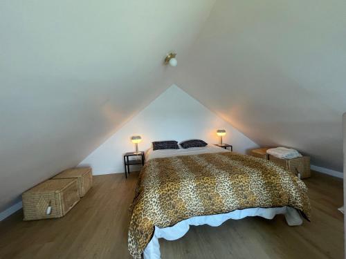 a bedroom with a large bed in a attic at Ty Lazo: Sérénité en bord de mer, havre de paix. in Plouézec