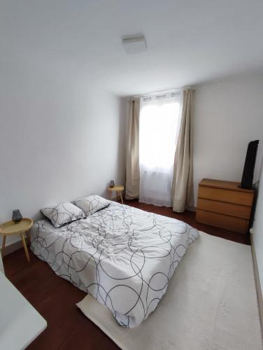 une chambre avec un grand lit et une fenêtre dans l'établissement Appartement rénové moderne 2 chambres à Montréjeau, à Montréjeau