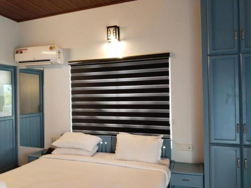 a bedroom with two beds and a large headboard at Eterno Camellia & Elettaria Resort with Pool in Munnar