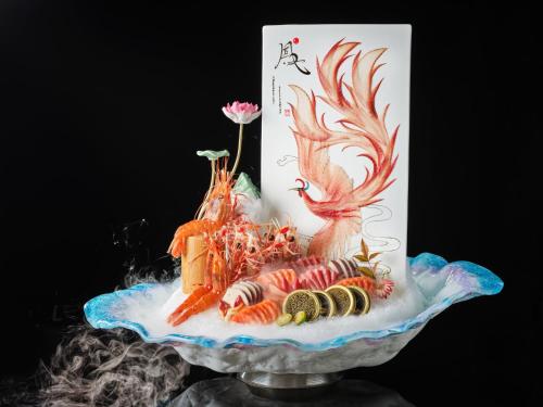 a cake with seafood on top of a glass plate at Crowne Plaza Suzhou by IHG in Suzhou