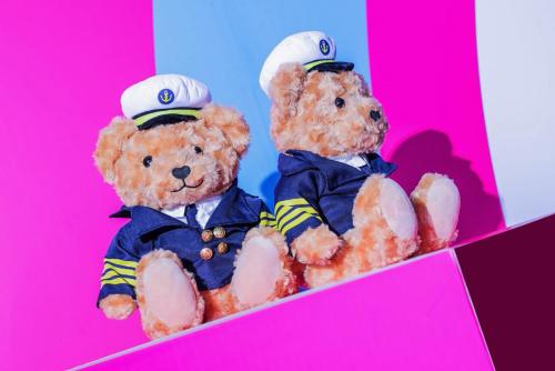 two teddy bears dressed in uniform sitting in a box at Crowne Plaza Suzhou by IHG in Suzhou