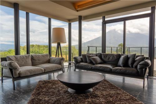 a living room with two couches and a table at MUSE Niseko in Kutchan