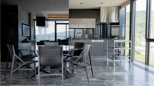 a kitchen with a table and chairs in a room at MUSE Niseko in Kutchan