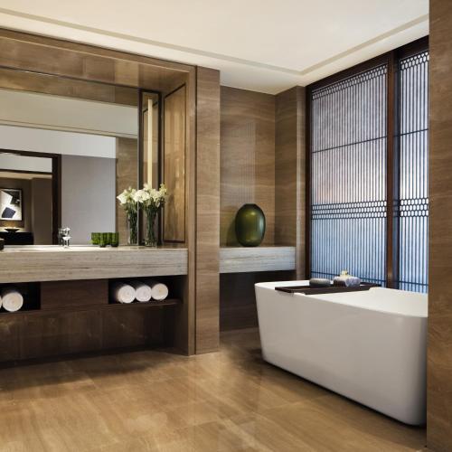 a bathroom with a tub and a mirror at JW Marriott Hotel Zhejiang Anji in Anji