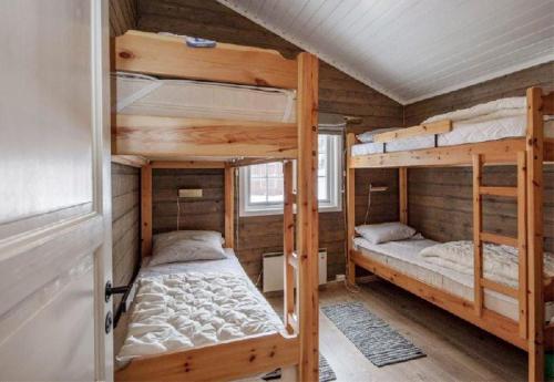 a bedroom with two bunk beds in a cabin at Sørlia hytte in Hafjell