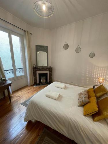 une chambre avec un lit avec deux serviettes dessus dans l'établissement LE SAINT JULIEN 3étoiles - Hypercentre - Proche Thermes - Balcon, à Vichy