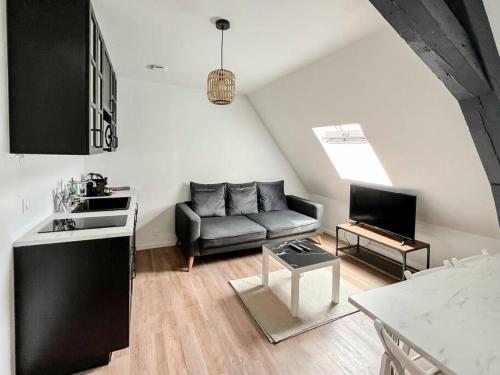 un salon avec un canapé et une table dans l'établissement COPENHAGUE- Cathédrale, Maison du XVI siècle, à Reims