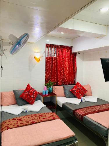 a room with two beds and a red curtain at Days Hostel Block D 24 HOUR RECEPTION BLOCK D 10TH FLOOR in Hong Kong