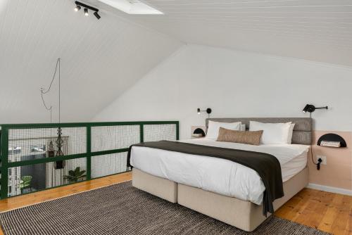 a bedroom with a large bed and a balcony at Neighbourgood Franschhoek in Franschhoek